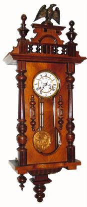 C.1900, German, Wall Regulator quarter hour strike, with Hour Glass type door and fancy embossed pendulum. — Antique Clocks Price Guide