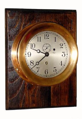 C.1939, Chelsea Clock Co., Ships Timepiece, 6" dial, red brass case with screw bezel, mounted on a soft wood board, stained dark. — Antique Clocks Price Guide