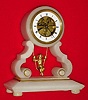 C.1890, French, Swinging Doll clock, in a white alabaster case, 8-day time only. 