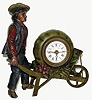 C.1900, French, A spelter novelty of a young farmer pushing a wheelbarrow containing garden vegetables, but notably a large squash which contains a 30 hour alarm clock. 