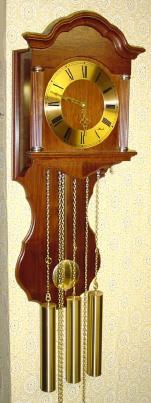 C.2000, German, Hermle, Westminster Wall clock, 3-weight, chain drive, in a walnut case with a shaped splat behind the pendulum. — Antique Clocks Price Guide