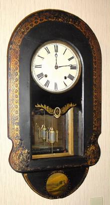 C.1875, Anglo-American Wall clock, 8-day striking movement signed E. N. Welch, the outer case of papier-m and acirc;che, painted black and with gold stenciling around the border and a painted scene at the bottom. — Antique Clocks Price Guide