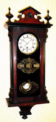 C.1890, German, Ribbon Calendar with separate rollers for month and day of week, each visible through orifice in gold leaf pattern on original tablet. — Antique Clocks Price Guide