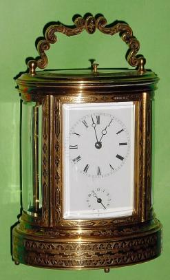 C.1880, French, Oval Brass Cased Carriage clock, with profuse geometric engraving, Grand Sonnerie, with repeat and alarm. — Antique Clocks Price Guide