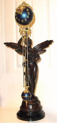 C.1895 Ansonia Clock Co., GLORIA SWING, clock, patinated spelter statue of goddess Gloria, with a harp in her left hand, holding her right arm aloft and supporting the ball swing clock that moves with no apparent impulse. — Antique Clocks Price Guide