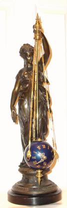 C.1890, French, Patinated Spelter, Unusual Conical, the movement contained within the pendulum ball which rotates in a circular fashion, motive power coming out the top of the ball with a little arm pushing against the tip of a rod. — Antique Clocks Price Guide