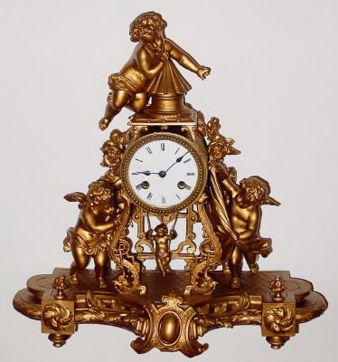 C.1890, French, 3-Cupids with Swinging Doll pendulum, 8-day time and bell strike, patinated spelter case. — Antique Clocks Price Guide