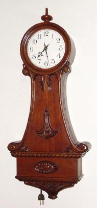 C.1904, American 110v Electric Banjo, in a nicely carved mahogany case and with porcelain dial. — Antique Clocks Price Guide