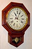 C.1915, Waterbury Clock Co., Short Drop Calendar, school timepiece, pressed oak case with 8-day movement.