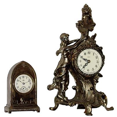 Lot of 2 novelty clocks: 1) Waterbury for Benedict Mfg, small cast metal desk clock, — Antique Clocks Price Guide