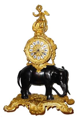 C.1860, French, L'Elephant, Bronze and Ormolu mantel clock, the clock and cupid surmounted above the elephants back. — Antique Clocks Price Guide