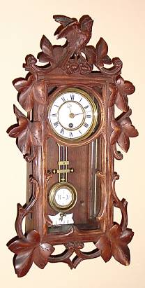 C.1890, German, Mini Spring R-A Wall clock, Black Forest, bird and leaf motif, Week duration; — Antique Clocks Price Guide