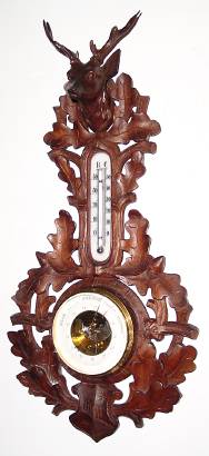 C.1890, German, Aneroid Barometer / thermometer in a nicely carved walnut case of oak leaves, deer head at top and shield at bottom. — Antique Clocks Price Guide