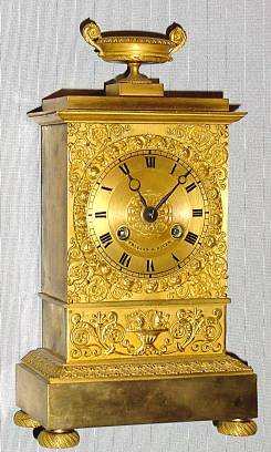 C.1825, French, Empire Mantle Clock, Small, the front with scrolls and floral decorations, the cast bezel of rose buds, 8-day time and bell strike with silk thread pendulum — Antique Clocks Price Guide
