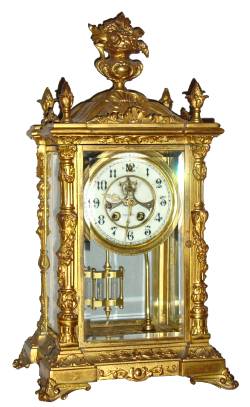 C.1900, Wm. L. Gilbert, VERDI Crystal Regulator, gilt spelter with columns at the corners and surmounted by a flower filled urn. — Antique Clocks Price Guide