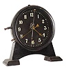 C.1921 English Gravity timepiece, The 30-hour movement is driven by a weight inside the case that raised by a lever on the side with visible escapement and a compound bar-bell pendulum. Serial No. L4447