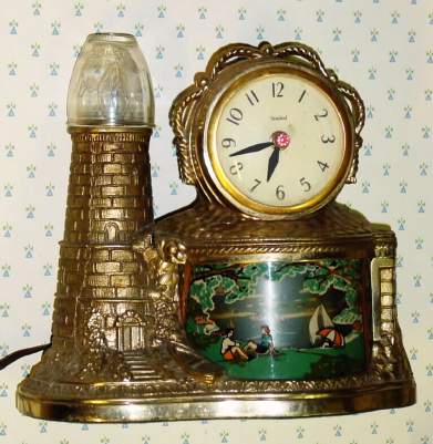C.1940, United Electric Clock Corp., Brooklyn, NY, Lighthouse, 110v, electric timepiece, the sail boats within the viewing area, moving from right to left while running. — Antique Clocks Price Guide