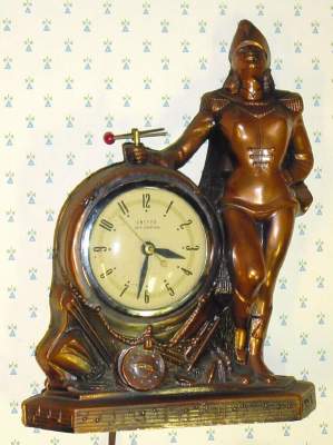 C.1950, United Electric Clock Corp, Brooklyn, NY MAJORETTE, 110v, timepiece, with red tipped baton spinning in the girls right hand over the clock. — Antique Clocks Price Guide