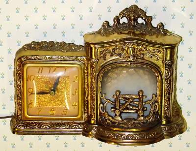 C.1950, United Electric Clock Corp, Brooklyn, NY FIREPLACE, 110v, timepiece, brightly colored imitation fire rolling in the fireplace to the right of the clock. — Antique Clocks Price Guide