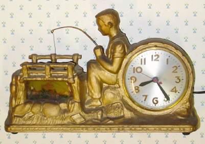 C.1940, Century Clock Co., NY, HUCKLEBERRY FINN , 110v, cast metal automaton, Huck's fishing pole bobbing up and down, two fish eluding his hook in the pond at left, lit by a soft pink light. — Antique Clocks Price Guide