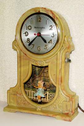 C.1940, Mastercrafters Clock and Radio Co., Chicago, SWINGING DOLL automaton timepiece, 110v, young tow head girl in a swing, ahead of a white picket fence in front of a cottage. — Antique Clocks Price Guide