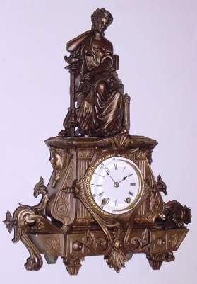 C.1874, Seth Thomas' Sons and Co, NY, "No. 8028", 8-day time and strike figural mantel clock, seated lady with a flute and sheet music in her lap, beside an oil lamp. — Antique Clocks Price Guide