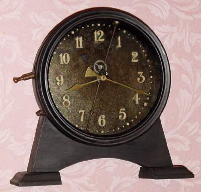 C.1921 English Gravity timepiece, The 30-hour movement is driven by a weight inside the case that is raised by a lever on the side with a visible escapement and a compound bar-bell pendulum, serial No. L5727. — Antique Clocks Price Guide