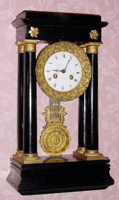 C.1870, French, 4-Column Empire Style ebonized case, 8-day time and bell strike mantel clock, new base, changed movement. — Antique Clocks Price Guide