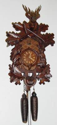 C.1995 German "Regula", 30-hour time/strike cuckoo clock, hunting motif with crossed rifles at top, deer head, rabbit and bird.. — Antique Clocks Price Guide