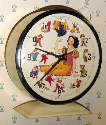 C.1965, Bayard, France, "Snow White" (Blanche Neige) , 30-hour novelty alarm timepiece (Blue Bird above Snow White's hand rocks back and forth as clock runs). — Antique Clocks Price Guide