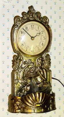 C.1950, Ceramic Clock Co, Chicago, WATERFALL timepiece, 110v, with spiral glass piece that rotates from a cast fountain to simulate running water. — Antique Clocks Price Guide