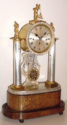 C.1830, Austrian, Musical Grand Sonnerie mantel clock, classic Continental style with silvered brass columns, the clock surmounted by 3 ormolu statues, 1-day winding, and playing one of two tunes after completing the hour strike. — Antique Clocks Price Guide