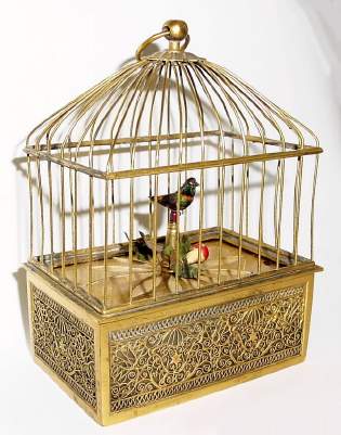 C.1965, Swiss, Singing Bird in Mini Cage, bottom wind, slide actuate, in a brass and filigree case. — Antique Clocks Price Guide