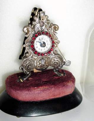 C.1850, Austrian, Zappler 30-hour timepiece, with silvered brass facade (casting), and ruby-like stones around the dial. — Antique Clocks Price Guide