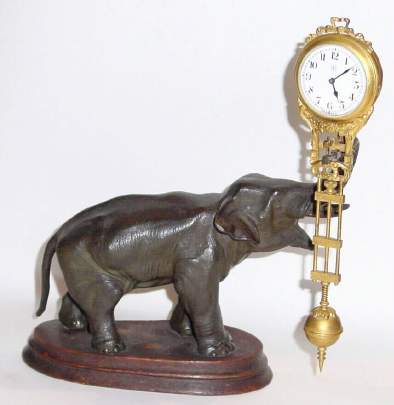 C.1910, German, Junghans, 8-Day Elephant swing clock, the clock arm supported by a jewel bar that extends from the tip of the elephants trunk. — Antique Clocks Price Guide