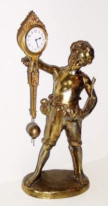 C.1900, German, Junghans, Uncommon swinging arm clock, boy with hand in his pocket, other arm supporting the clock. — Antique Clocks Price Guide