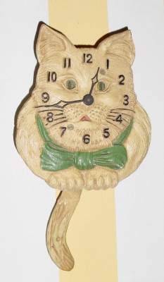 C.1937, Lux Clock Mfg. Co., Waterbury, Conn., "Cat D243", 30-hour novelty timepiece, white/tan. — Antique Clocks Price Guide