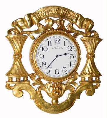 C.1910, E. F. Caldwell, New York, Gilt bronze wall timepiece, with top banner TEMPUS FUGIT; Jeweled lever movement, hinged into case, rear wind and set, 8-day. — Antique Clocks Price Guide