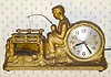  C.1940, Century Clock Co., NY, HUCKLEBERRY FINN , 110v, cast metal automaton, Huck's fishing pole bobbing up and down, two fish eluding his hook in the pond at left, lit by a soft pink light. 