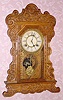  C.1906, Waterbury Clock Co., "Felix" , 8-day time and strike oak gingerbread clock. 