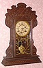  C.1906, Waterbury Clock Co., "Harlem" , 8-day time and strike walnut gingerbread clock. 