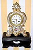  C.1840, French, B and C, Paris, gold and floral decorated porcelain clock on carved wooden base. 