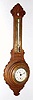  C.1900, Waterbury Novelty, Clock-Barometer in an oak wall case, and with Fahrenheit thermometer, marked for Blood Heat, Temperate, Freezing and Zero on a brass scale. 