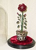  C.1890, French, Flower Clock, rare motif, with central petals revolving as the minutes, indicated by a tiny brass bug, next petal ring revolving as the hours, indicated by a fluttering insect of brass, and the numerals delicately painted on the outer 12 petals. The movement is contained within the flower pot, unsure of duration, but at least one day, perhaps more. 