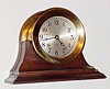  C.1978 Chelsea Clock Co., Boston. Mass., 8-day ship's bell clock, serial no. 813312 in a polished brass case, on original mahogany stand, 4 1/2" dial.