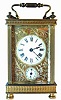  C.1910, French Brass Cased Carriage clock, time and alarm with a floral mask. 