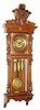  C.1890, German, Gustav Becker, 3-Weight Grand Sonnerie wall clock in walnut and veneers, in double door style with bracket base and applied brass trim. 