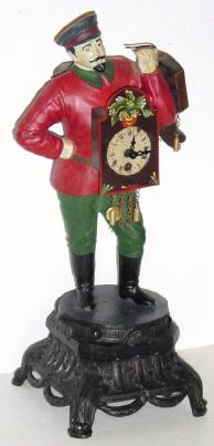 C.1955, German version of a Russian Clock Peddler, cast white metal make figure with cap and goatee, holding 3 clocks, the front clock with spring driven pendulette movement, 30 hour. — Antique Clocks Price Guide