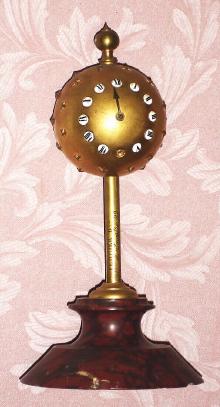 C.1875, French, Ferrier Bte, Montmartre 22, unknown duration gravity timepiece, a star studded gilt bronze ball that descends a central pole. — Antique Clocks Price Guide