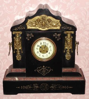 C.1890, French, Black Slate and Bronze mantel clock, 8-day time and gong strike, with porcelain dial, with fancy bronze center. — Antique Clocks Price Guide